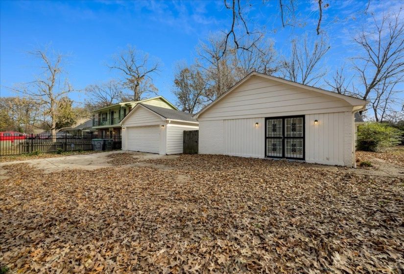 View of front facade with a garage, concrete driveway, and an outdoor structure