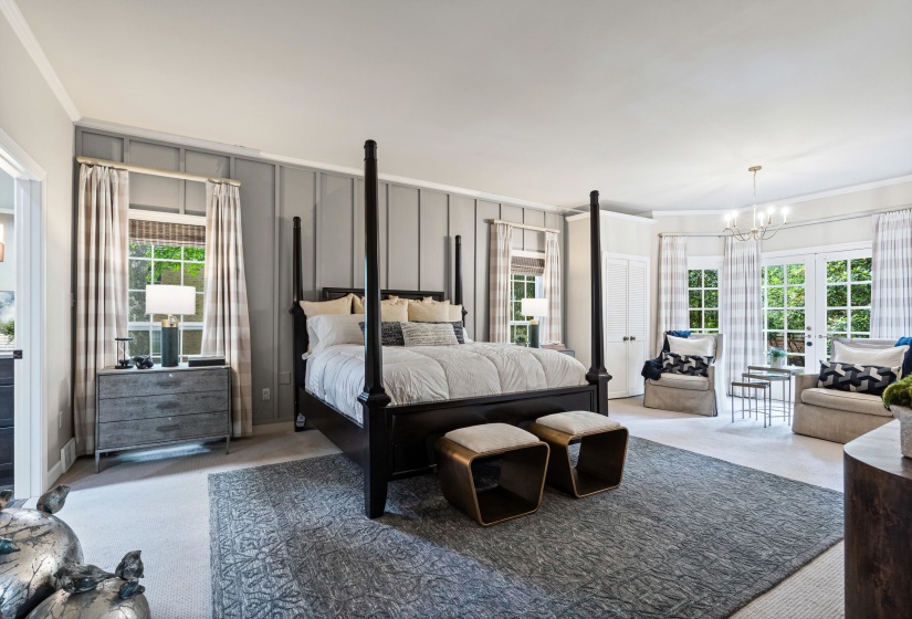 Spacious room featuring board and batten accent walls, light-toned carpeting, and a large area rug