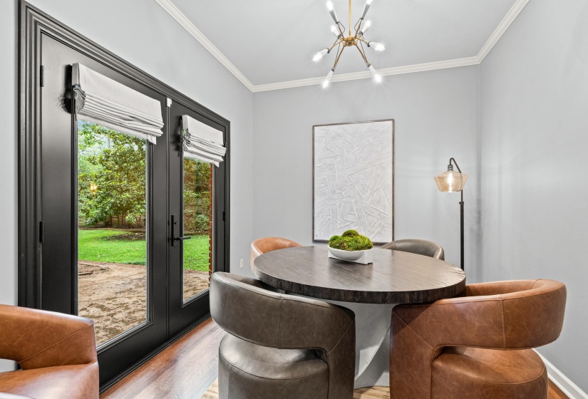 French doors featuring dark trim and privacy shades