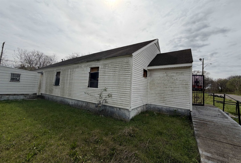 White vinyl siding exterior with an asphalt shingle roof