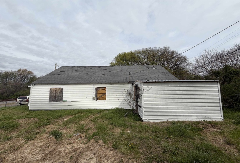 White siding exterior with a dark shingle roof