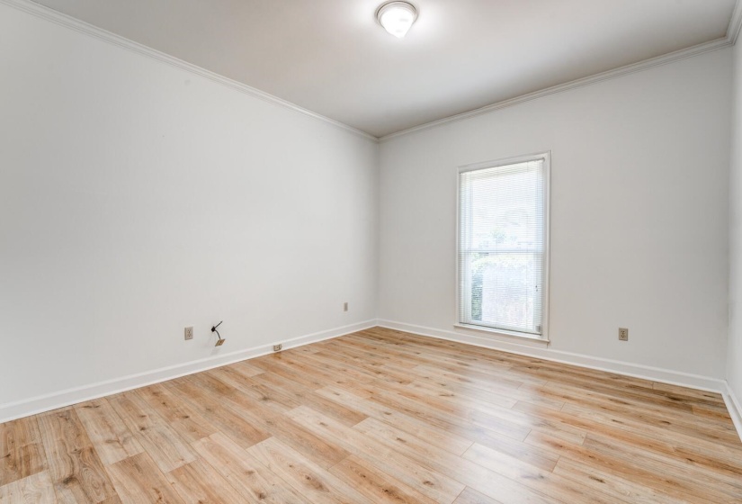 Room featuring light wood-finish flooring and white baseboards