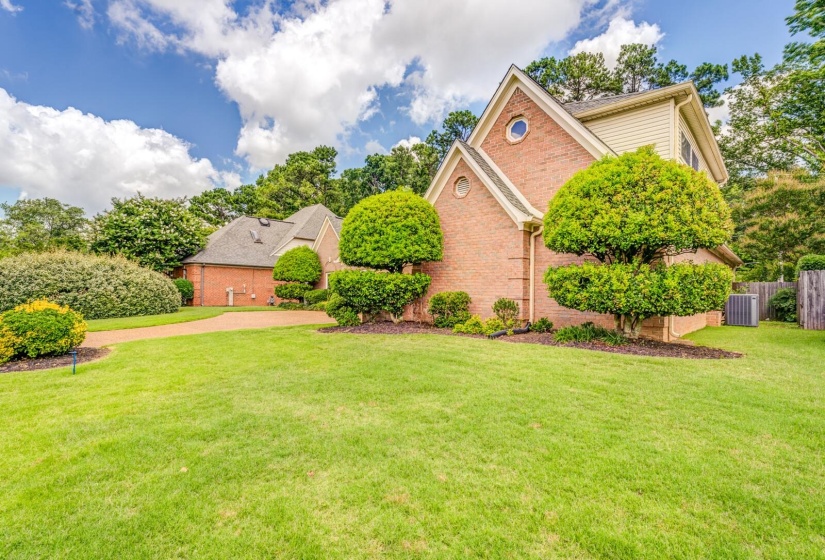 Brick exterior with dormer window, round accent window, and gabled roofline