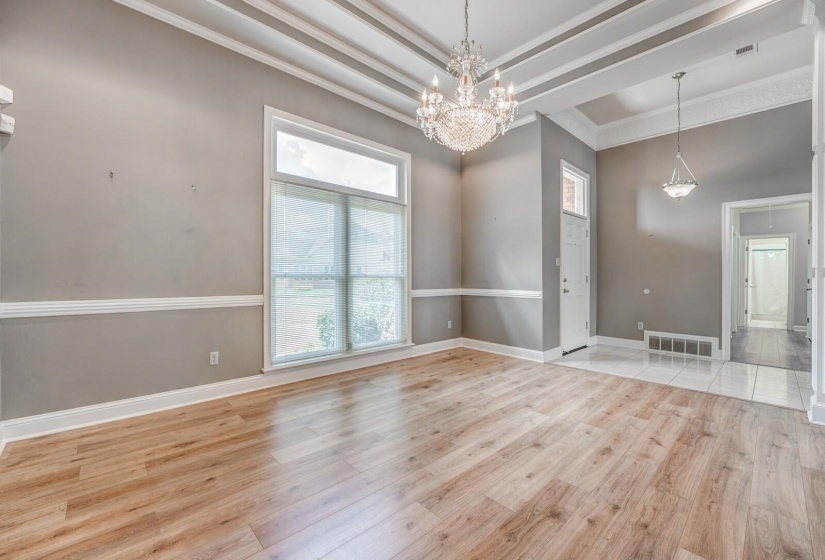 Spacious interior with wood-finish flooring and a coffered ceiling