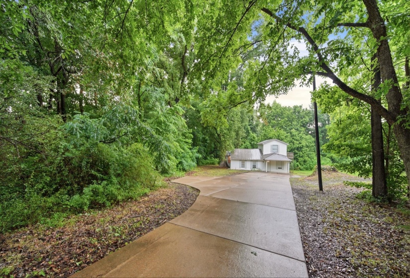 Very Nice concrete drive leading to home from Hwy.2 side parking spots.