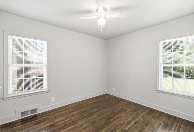 Hardwood-finish flooring paired with light wall tones and white trim