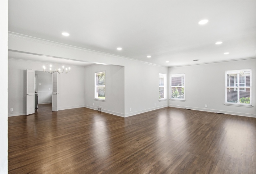 Spacious room featuring wood-finish flooring, recessed lighting, and multiple windows