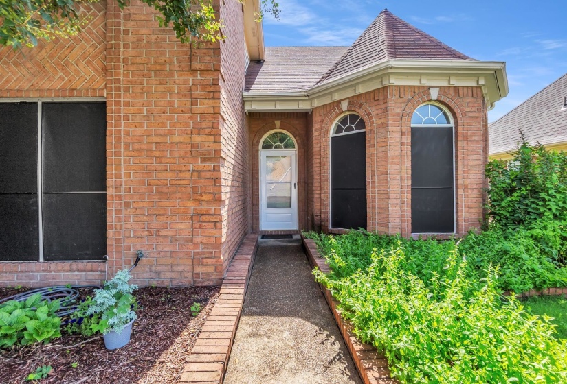 Brick exterior featuring a turret-style architectural element with arched windows